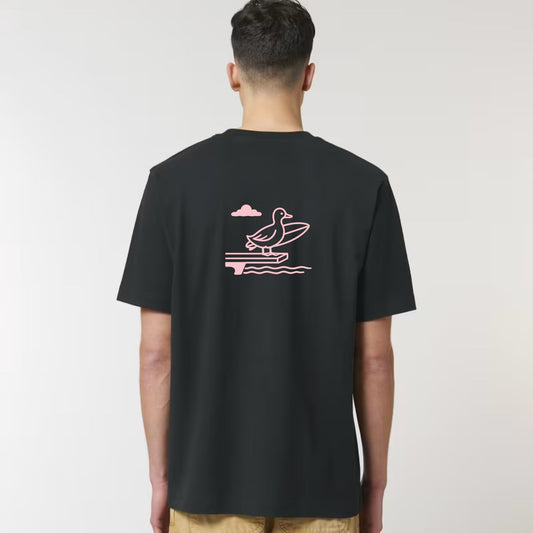 Person wearing a black t-shirt with a pink duck graphic on the back against a white background