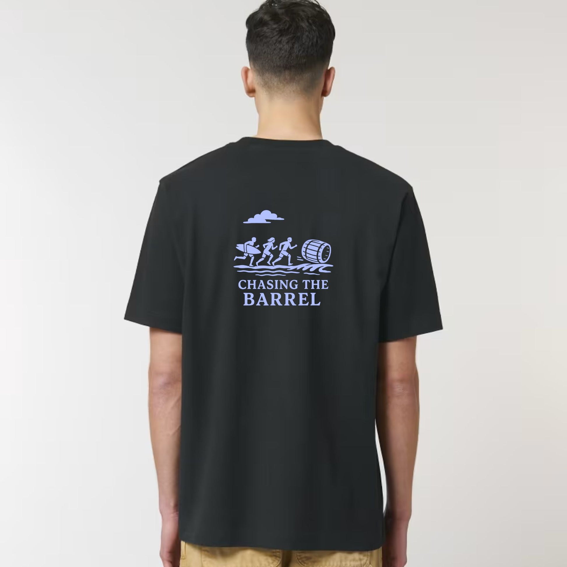 Person wearing a black t-shirt with 'Chasing the Barrel' graphic on the back against a white background
