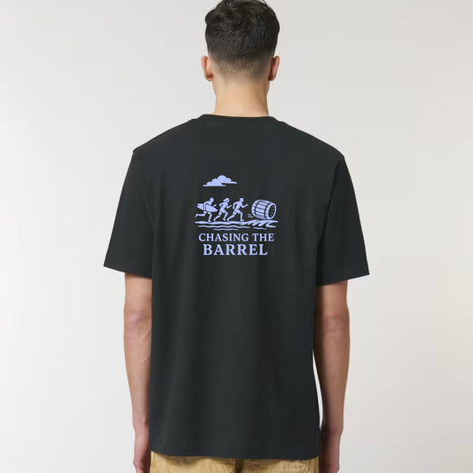 Person wearing a black t-shirt with 'Chasing the Barrel' graphic on the back against a white background
