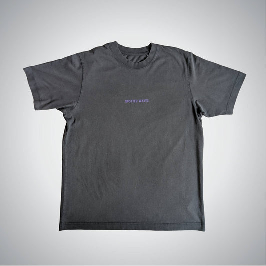 Gray t-shirt with a small logo on a light gray background