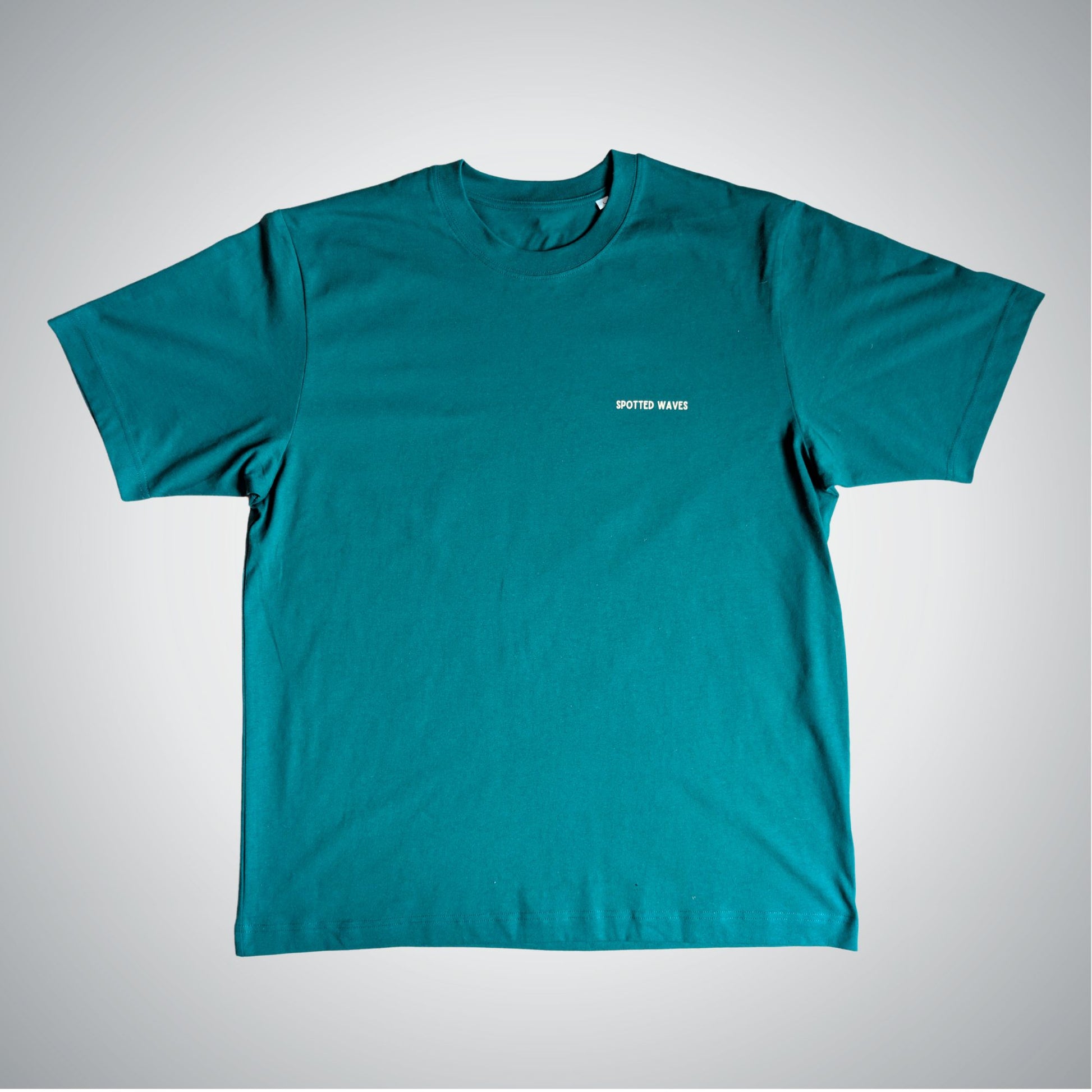 Teal t-shirt with a small white logo on a light gray background