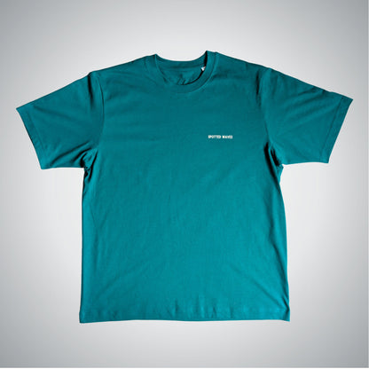 Teal t-shirt with a small white logo on a light gray background