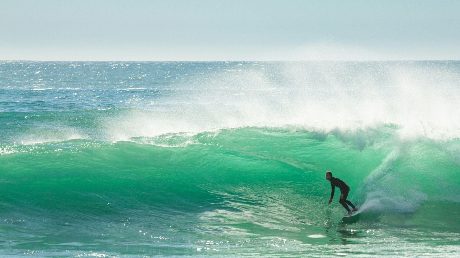 Surfer riding a large wave in the ocean